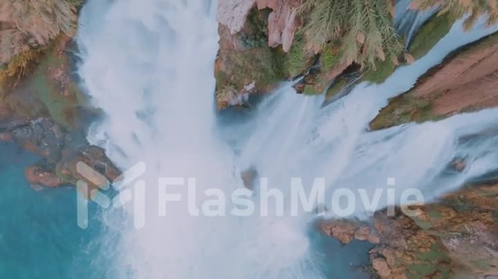 Aerial drone footage of the waterfall, turquoise water and rocky shore. Wildlife. The element of water.