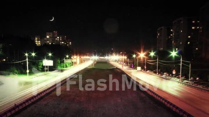 Cars go on night city which is shone by lanterns, time lapse