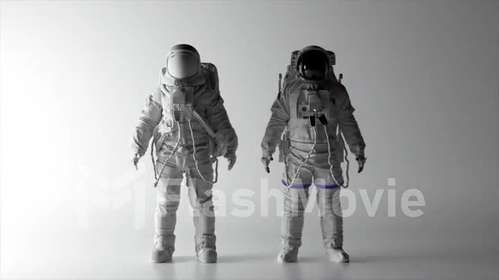 Two astronauts in white spacesuits stand on a white background. Black and white helmet. Shadows on the wall.