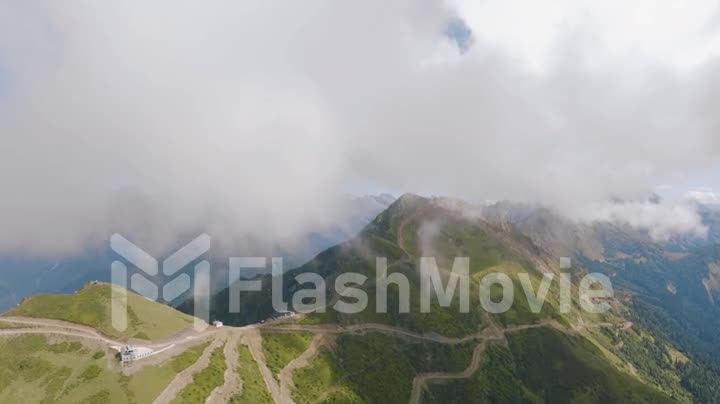 Foggy landscape. Haze. Drone video footage of green mountains and clouds. Green forest on the slopes of the mountains