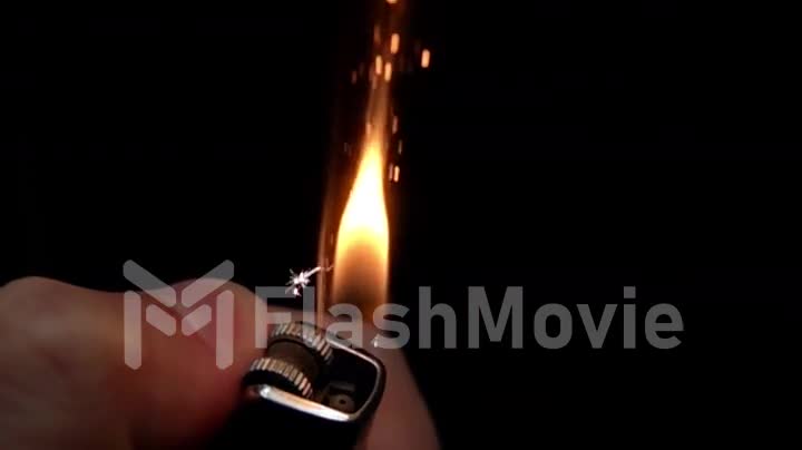 Using a lighters hand on a black background, slow motion
