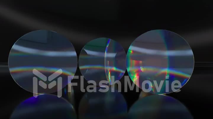 Colorful translucent glass lenses rotate and rotate on a dark background. 3d animation of a seamless loop